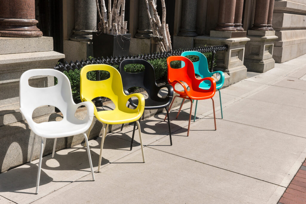 colorful chairs on sidewalk, sunny day